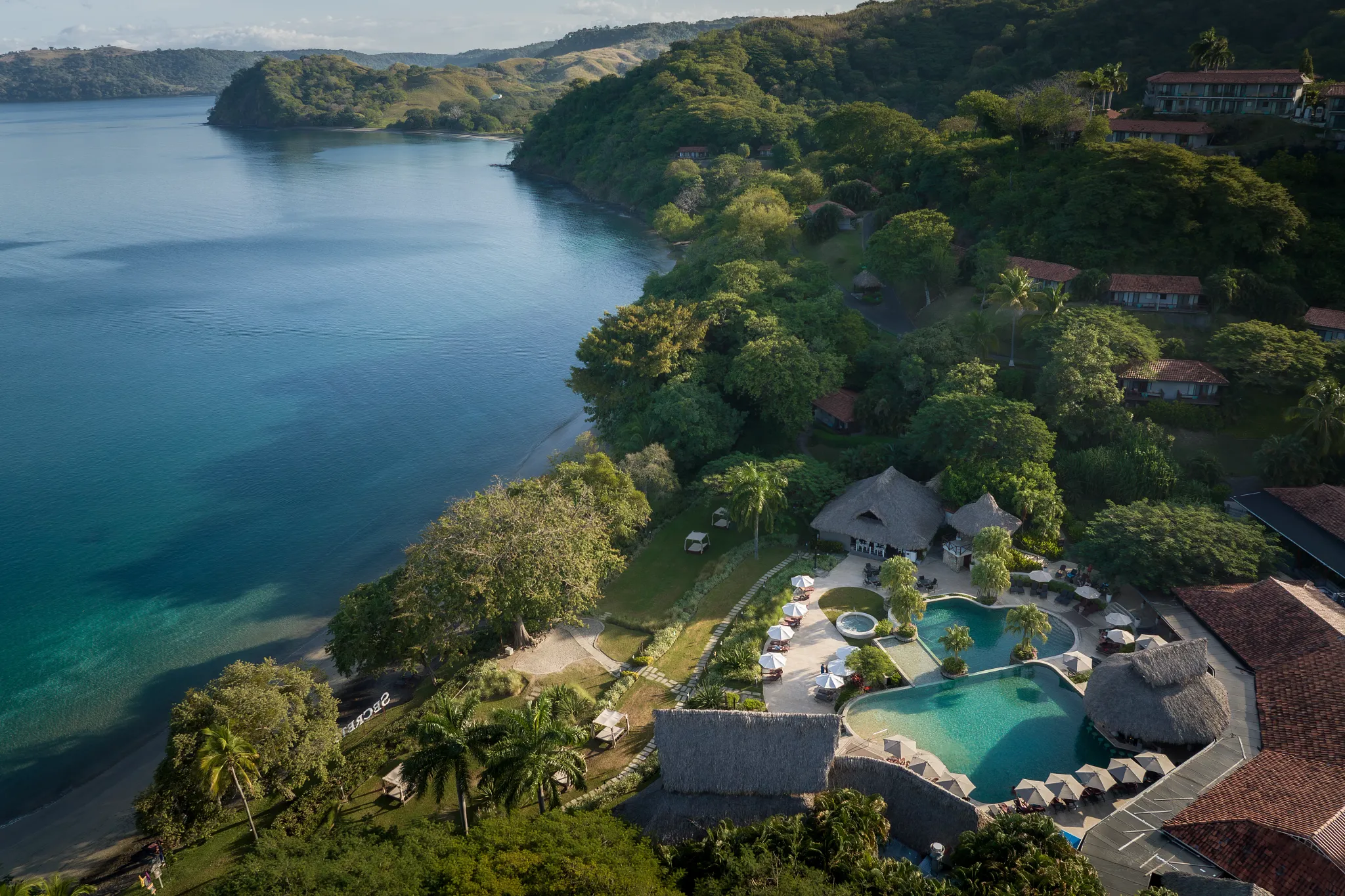 Aerial view of the pool and coastline at Secrets Papagayo Costa Rica overlooking the Pacific Ocean.
