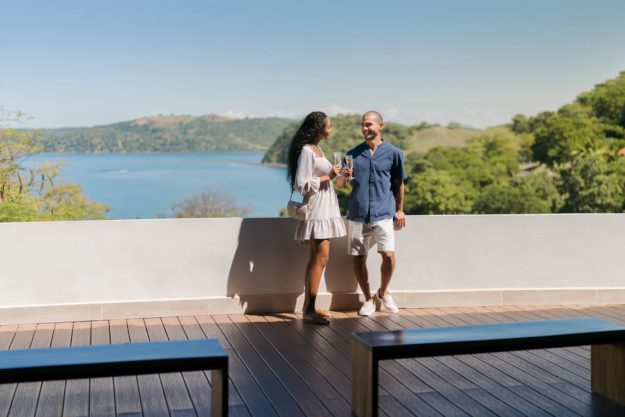 Couple enjoying panoramic bay views from the open-air lobby at Secrets Papagayo Costa Rica.