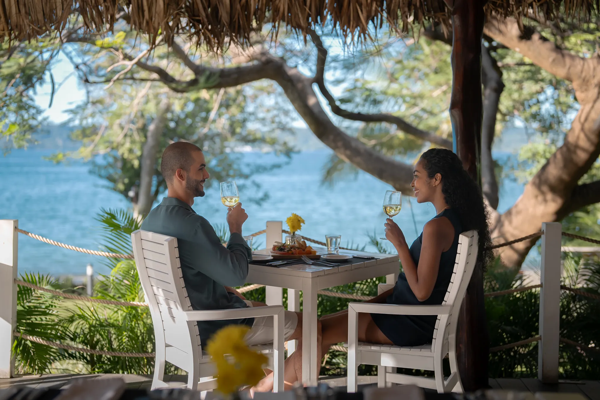 Couple enjoying a romantic oceanfront dining experience at Secrets Papagayo Costa Rica with tropical views.