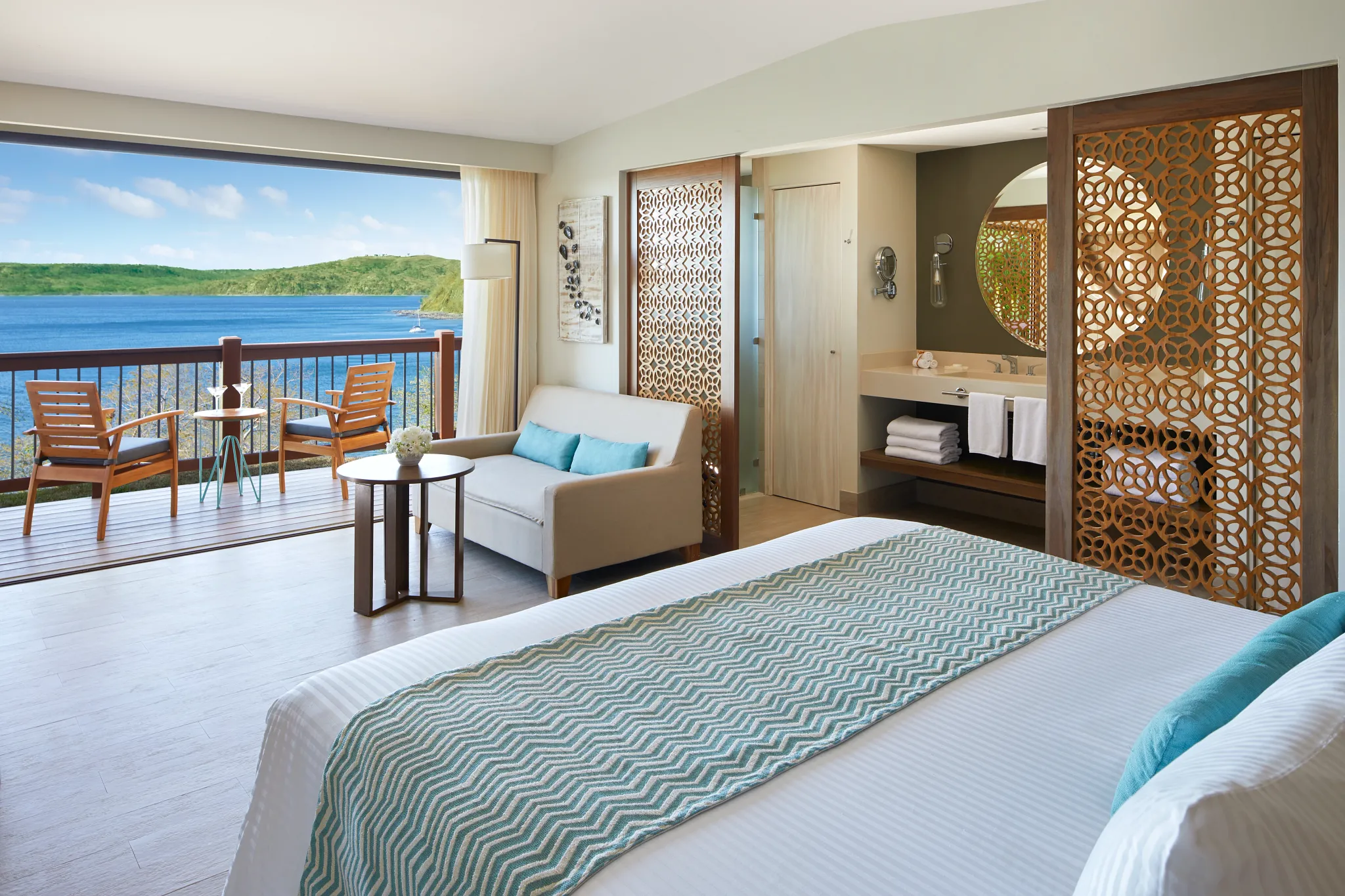 Preferred Club Bungalow Suite Ocean View interior with seating area and balcony access at Secrets Papagayo Costa Rica.