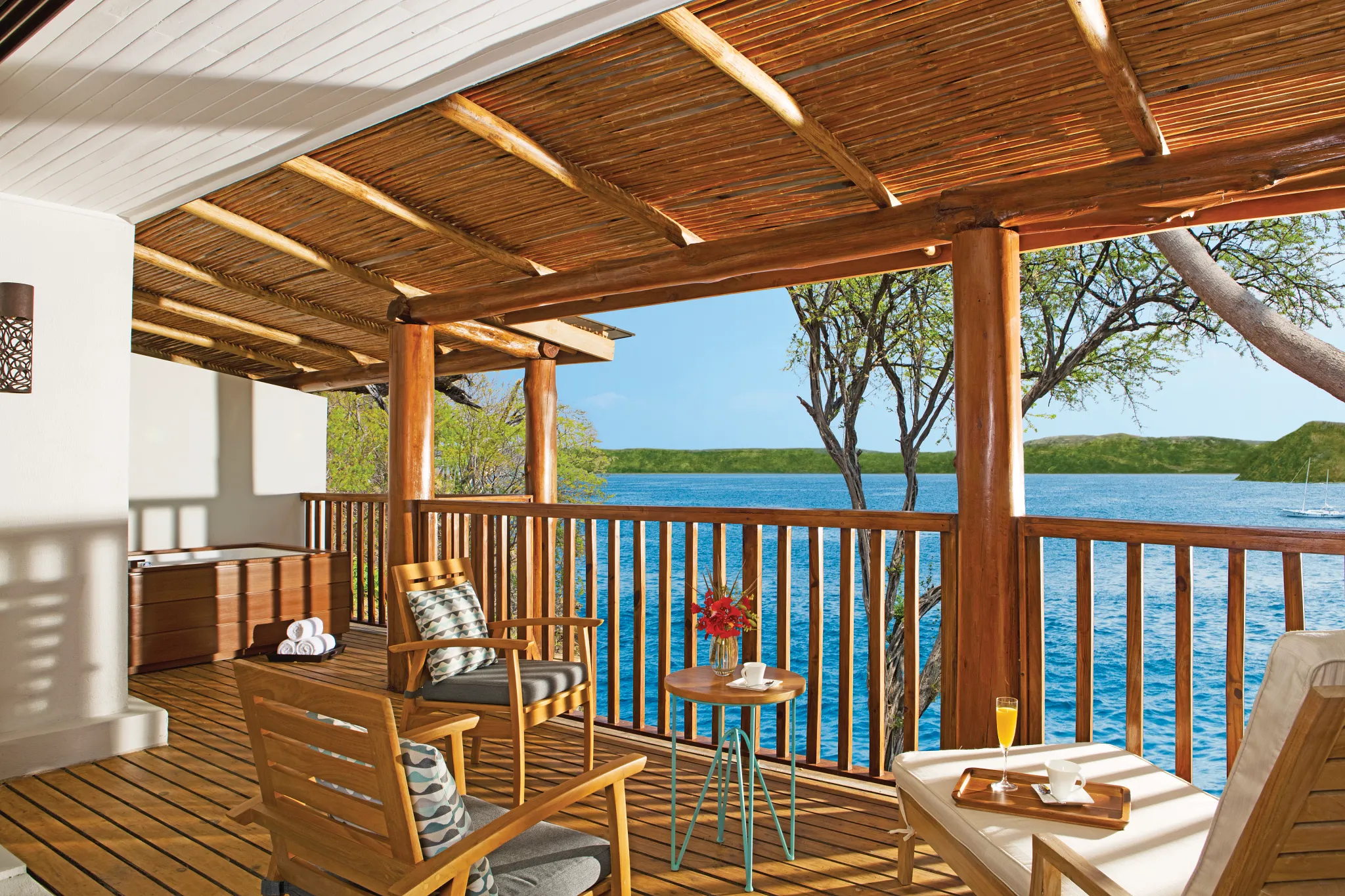 Private oceanfront terrace with seating at the Preferred Club Junior Suite in Secrets Papagayo Costa Rica.