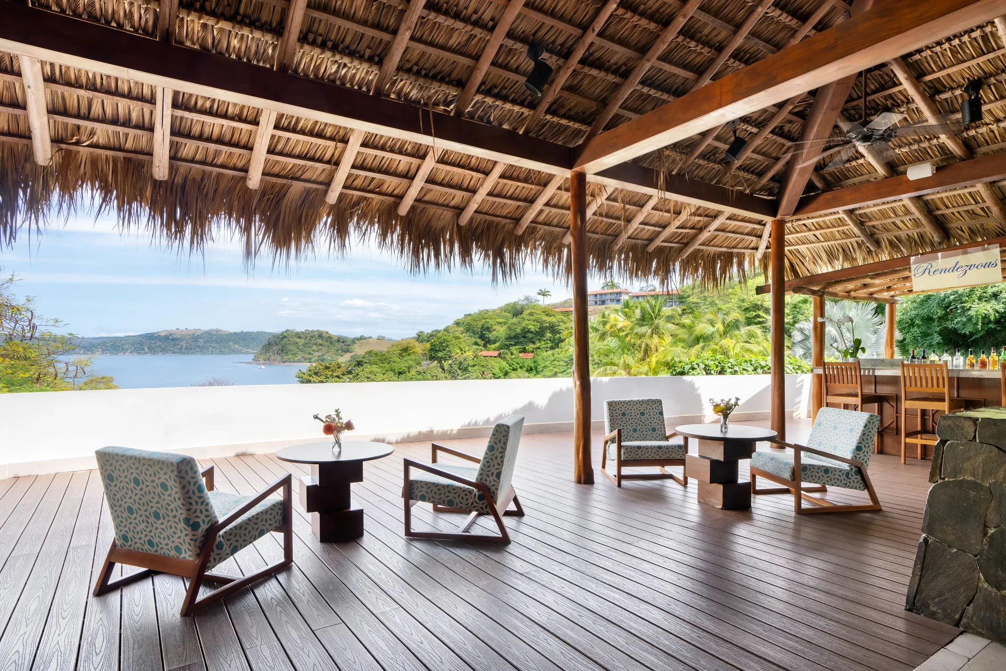 Rendezvous Lobby Bar at Secrets Papagayo Costa Rica featuring an open-air lounge with thatched roof, stylish seating, and panoramic ocean views.