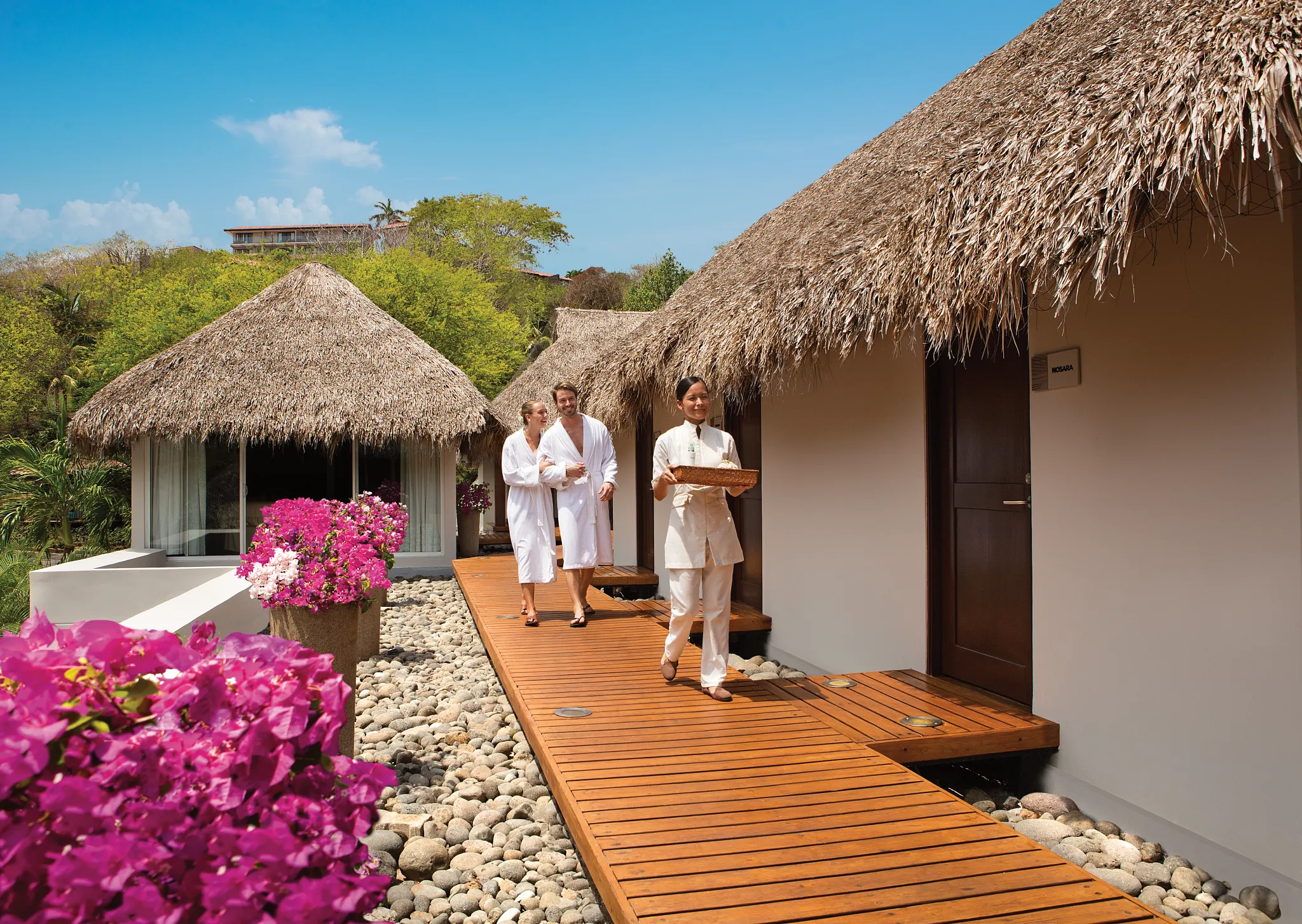 Outdoor spa cabins walkway surrounded by tropical landscaping at Secrets Papagayo Costa Rica.